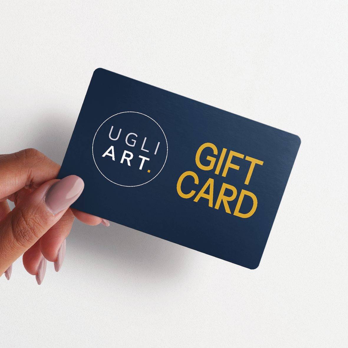 Hand holding an Ugli Art gift card