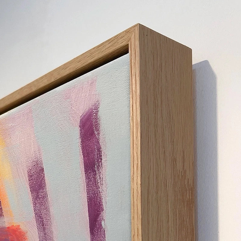 Close up of the top corner of a large oak framed canvas print of the artwork named Cafe Vibe